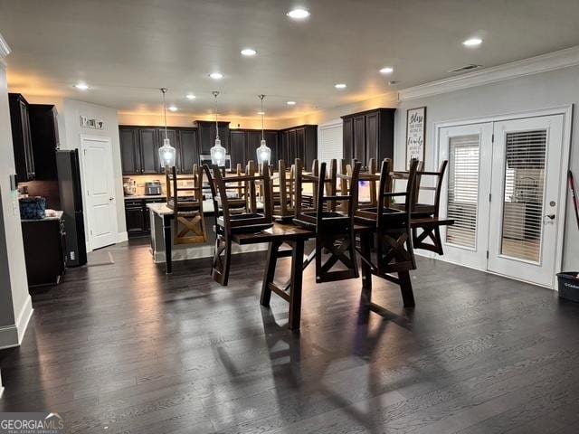 dining room featuring dark wood-style floors, crown molding, and recessed lighting