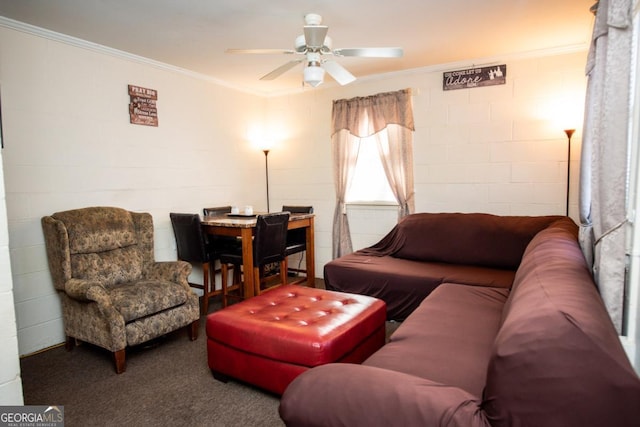 carpeted living room featuring ornamental molding, a ceiling fan, and concrete block wall