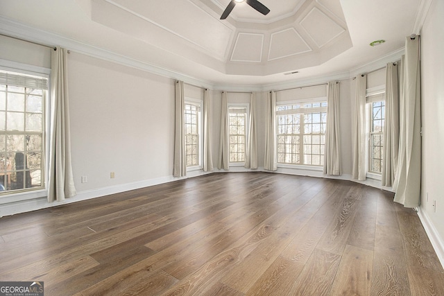 spare room featuring ceiling fan, dark wood-style flooring, coffered ceiling, baseboards, and crown molding