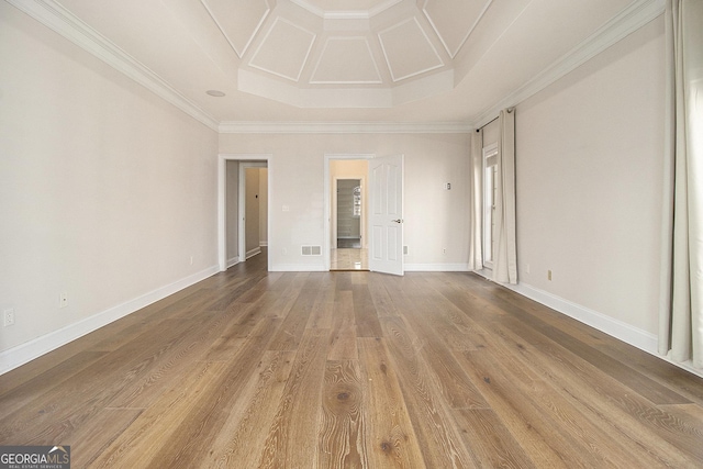 interior space featuring coffered ceiling, wood finished floors, visible vents, baseboards, and ornamental molding