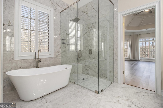 full bath with marble finish floor, a soaking tub, a shower stall, and tile walls