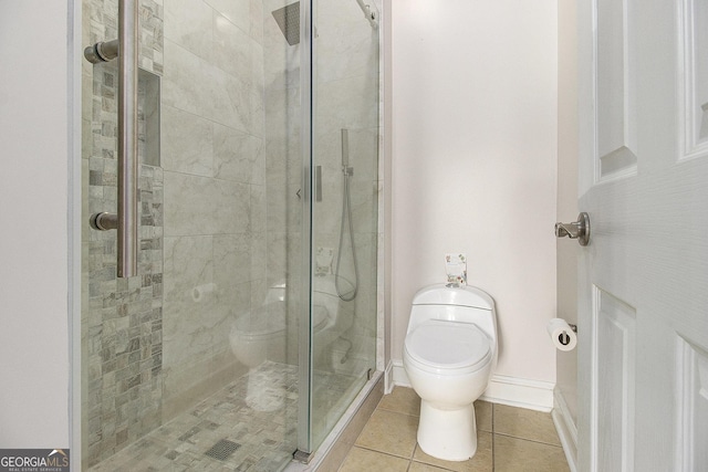 full bath with tile patterned flooring, baseboards, a shower stall, and toilet