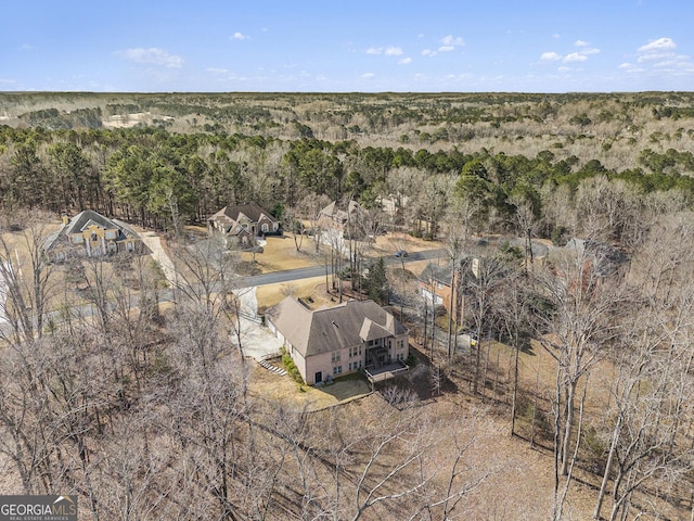 birds eye view of property featuring a view of trees