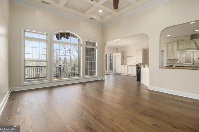 unfurnished living room featuring dark wood-type flooring, coffered ceiling, a high ceiling, and baseboards