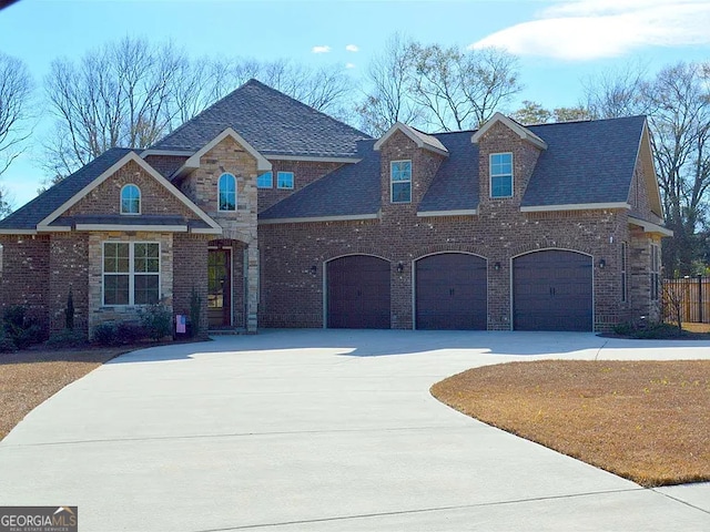 view of front of property with driveway, brick siding, and an attached garage