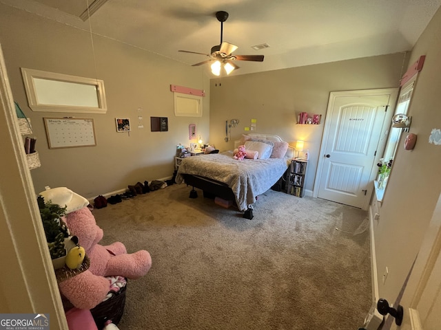 bedroom with attic access, visible vents, ceiling fan, vaulted ceiling, and carpet floors