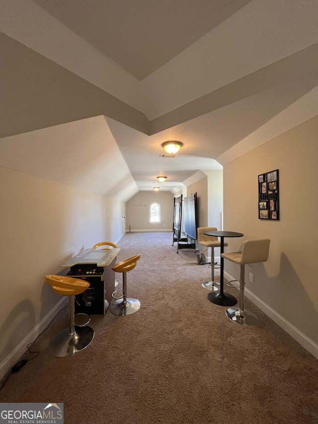 additional living space featuring lofted ceiling, baseboards, and carpet flooring