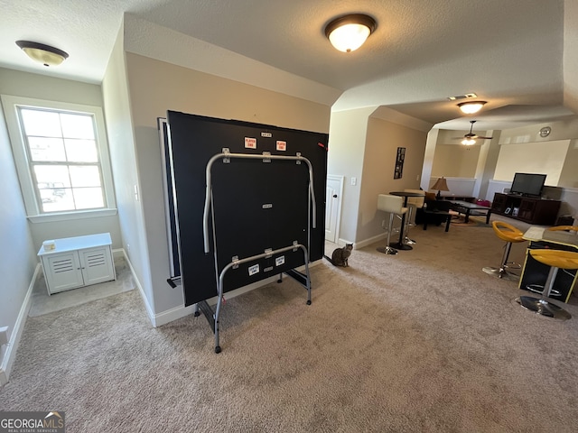 interior space featuring a textured ceiling, carpet flooring, visible vents, and baseboards