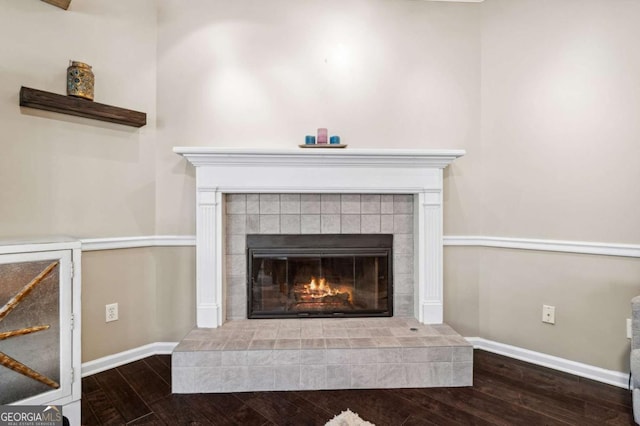 interior details with a fireplace, baseboards, and wood finished floors