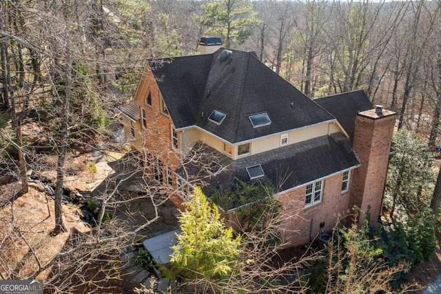 drone / aerial view featuring a wooded view