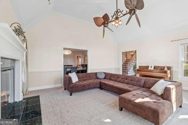 living room featuring high vaulted ceiling, a tile fireplace, a notable chandelier, carpet flooring, and baseboards