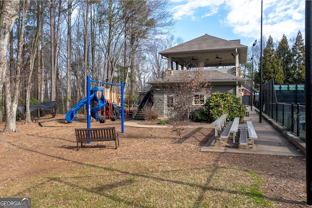 communal playground featuring fence and a ceiling fan