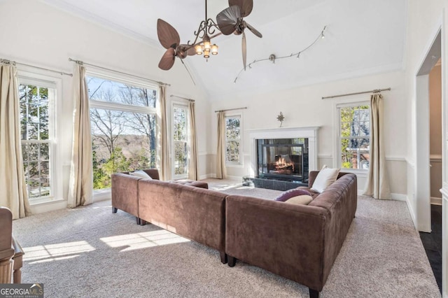 living room with carpet floors, high vaulted ceiling, plenty of natural light, and a tile fireplace