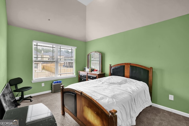 carpeted bedroom with baseboards and vaulted ceiling