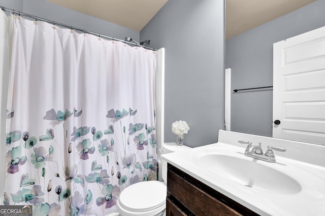 full bathroom with curtained shower, vanity, and toilet