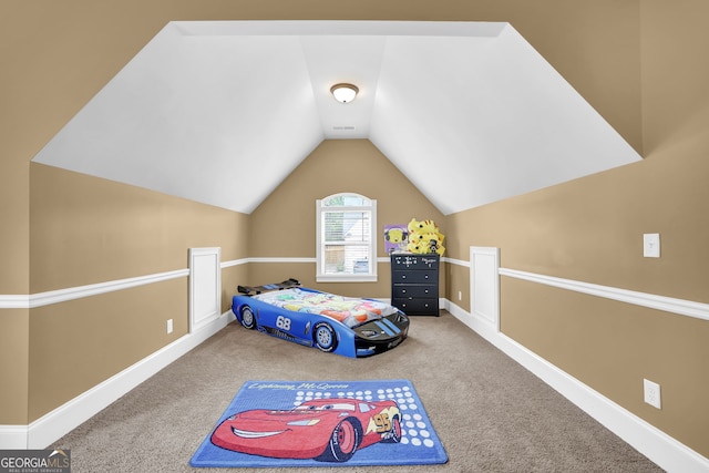 carpeted bedroom with baseboards and vaulted ceiling