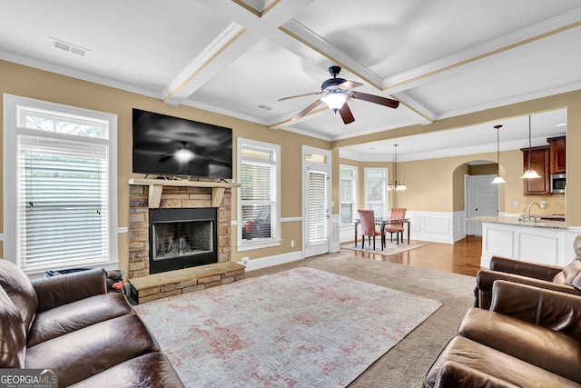 living area with a wealth of natural light, coffered ceiling, beam ceiling, and visible vents