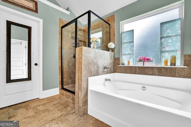 bathroom with a stall shower and a garden tub