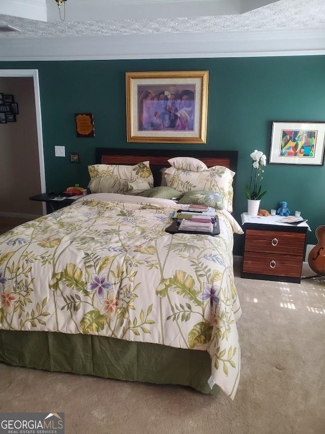 bedroom with ornamental molding, carpet flooring, and visible vents