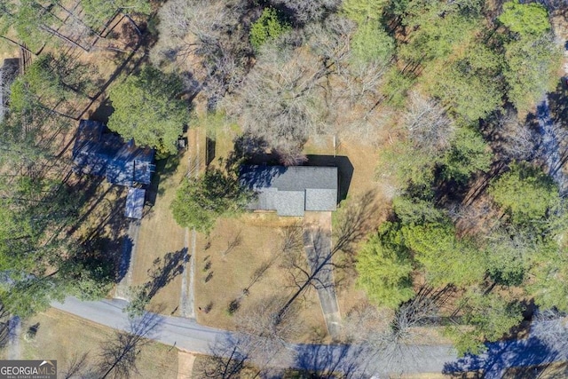 bird's eye view featuring a wooded view