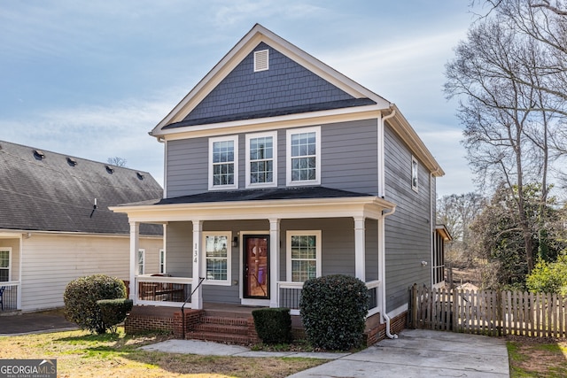 view of front of property featuring a porch and fence