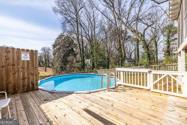 view of swimming pool with fence, a deck, and a fenced in pool