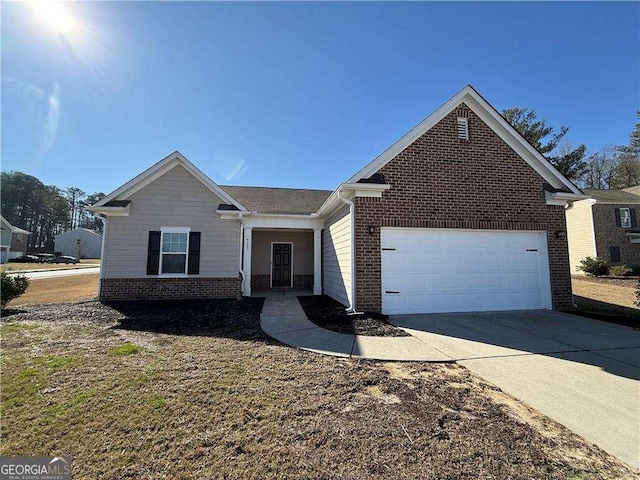 single story home featuring an attached garage, driveway, and brick siding