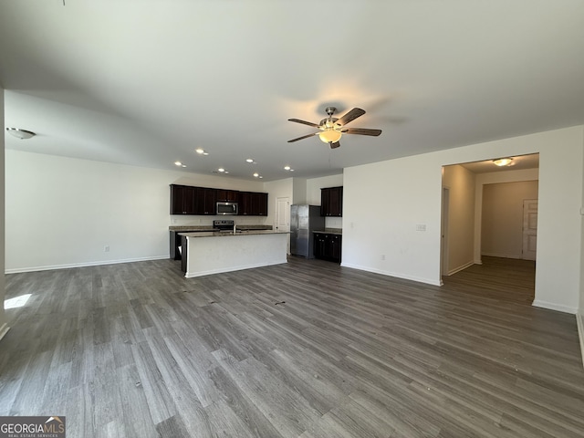 unfurnished living room with a ceiling fan, baseboards, dark wood-style flooring, and recessed lighting