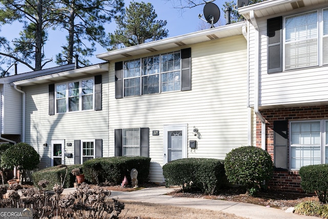 townhome / multi-family property with brick siding