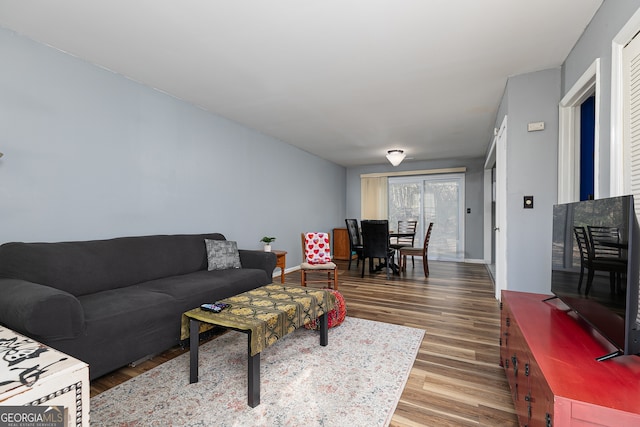 living area with wood finished floors and baseboards