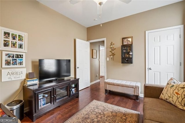 living room with baseboards, a ceiling fan, and wood finished floors