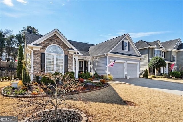 view of front of property featuring stone siding, driveway, a chimney, and fence