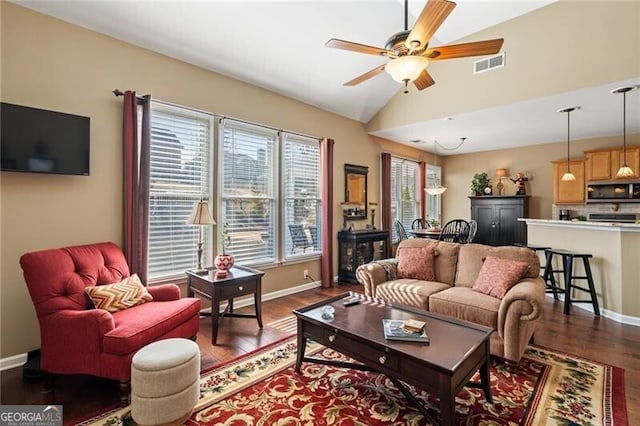 living area featuring visible vents, dark wood finished floors, baseboards, lofted ceiling, and ceiling fan