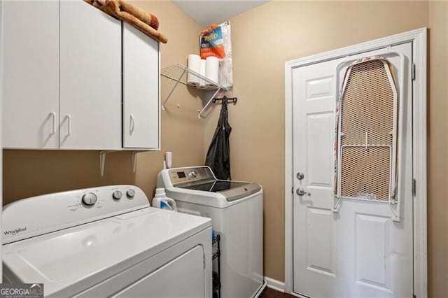 washroom with cabinet space and washer and dryer