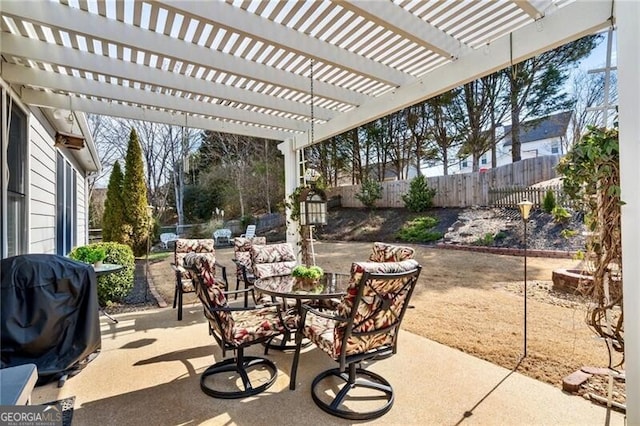 view of patio with outdoor dining space, grilling area, and a fenced backyard