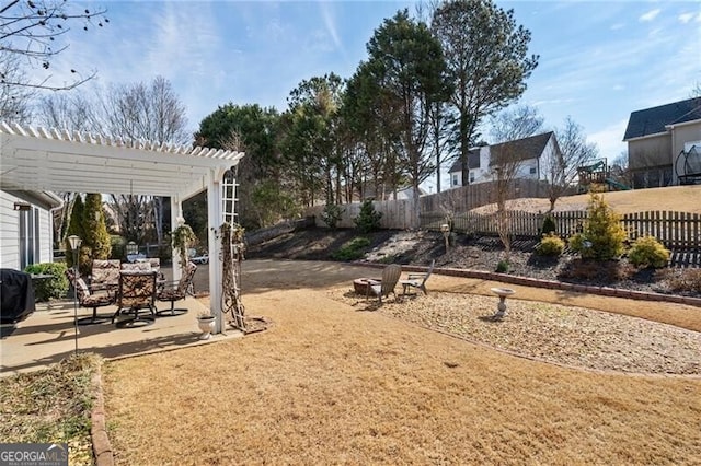 view of yard with a fenced backyard, a pergola, and a patio