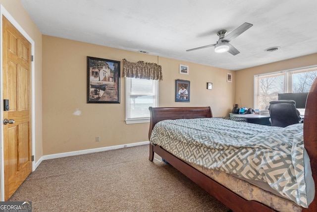 carpeted bedroom with multiple windows, visible vents, and baseboards