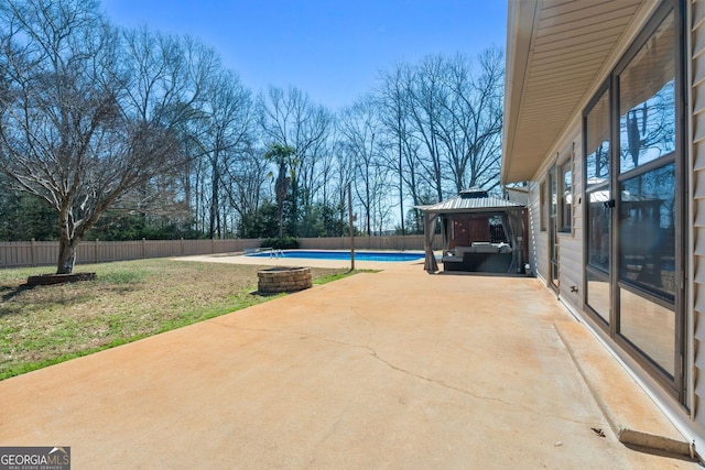 view of patio featuring a fenced backyard, a fenced in pool, and a gazebo