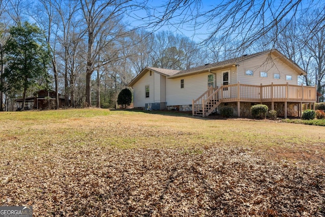 exterior space featuring a deck, stairway, a front yard, and cooling unit