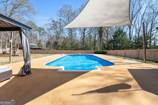 view of swimming pool featuring a patio area, a fenced backyard, and a fenced in pool