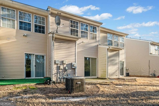 rear view of property featuring cooling unit