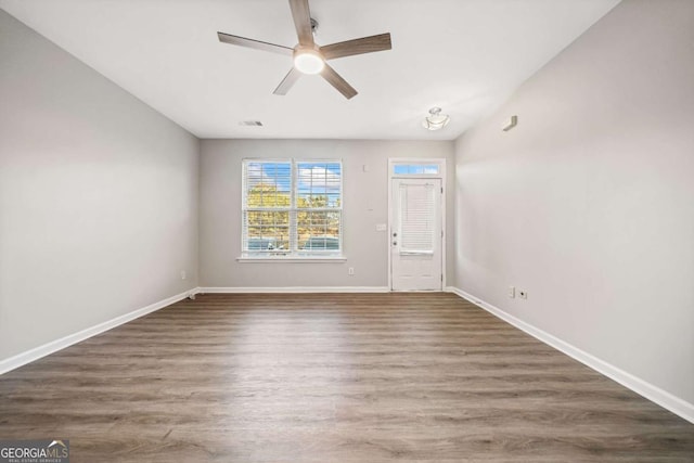 entrance foyer with a ceiling fan, visible vents, baseboards, and wood finished floors