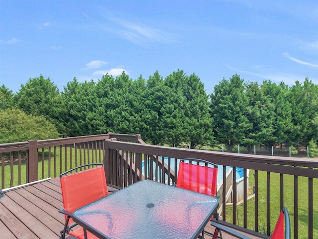 deck featuring a yard and outdoor dining space