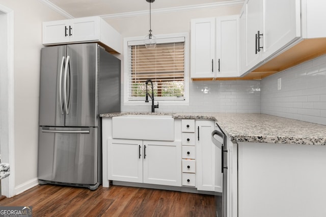 kitchen featuring dark wood-style flooring, a sink, white cabinetry, ornamental molding, and freestanding refrigerator