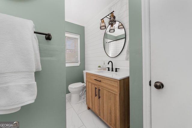 full bath with toilet, marble finish floor, ornamental molding, and vanity