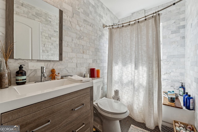 full bathroom with a shower with shower curtain, toilet, tile walls, and vanity