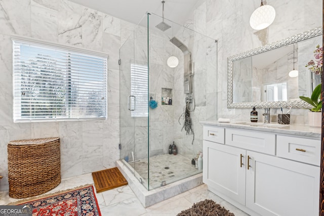 bathroom with tile walls, marble finish floor, and a shower stall