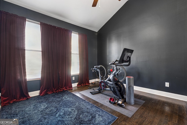 workout room featuring vaulted ceiling, wood finished floors, a ceiling fan, and baseboards