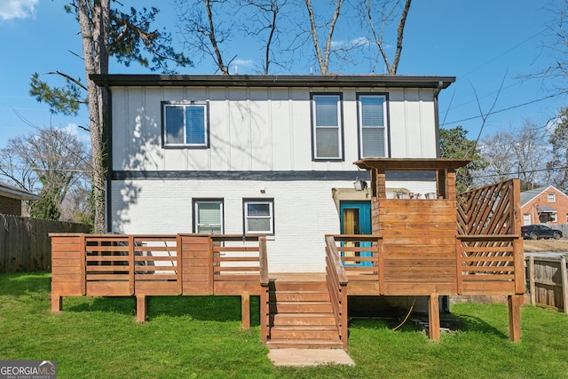 back of house featuring a yard, a fenced backyard, board and batten siding, and a wooden deck