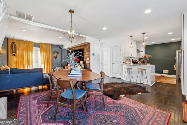 dining area featuring dark wood finished floors, visible vents, and recessed lighting